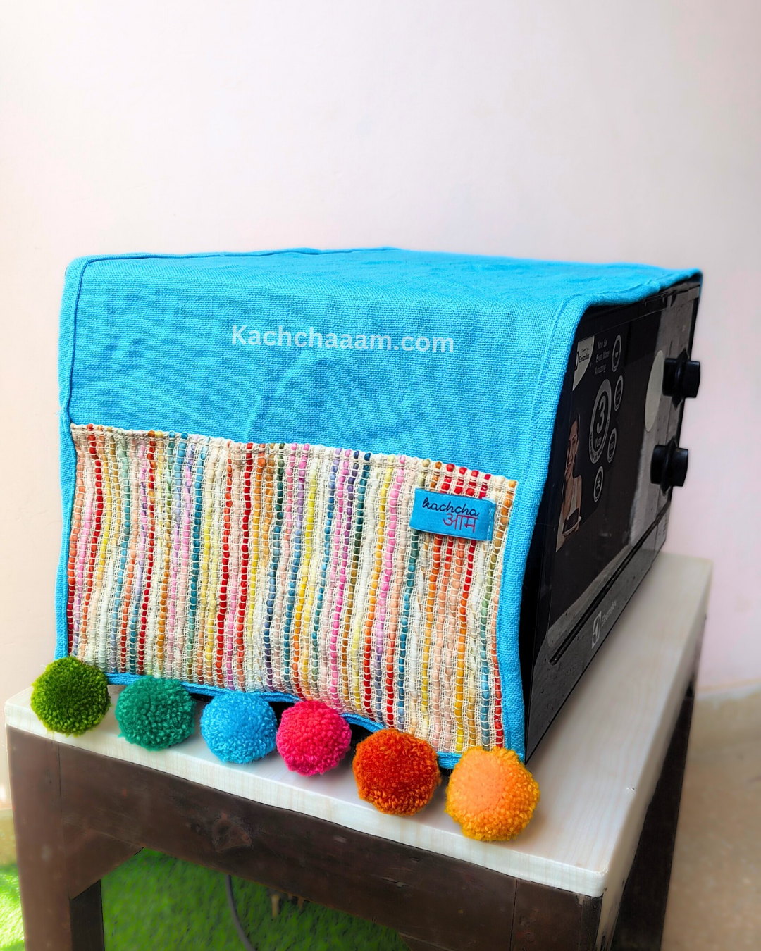 Sky Blue Cotton Slub Solid Microwave Cover with Multicolored Jacquard Fabric Pockets and Rainbow Pompom